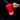 Mano sosteniendo un vaso térmico rojo Coca-Cola con asa, dentro de un auto.